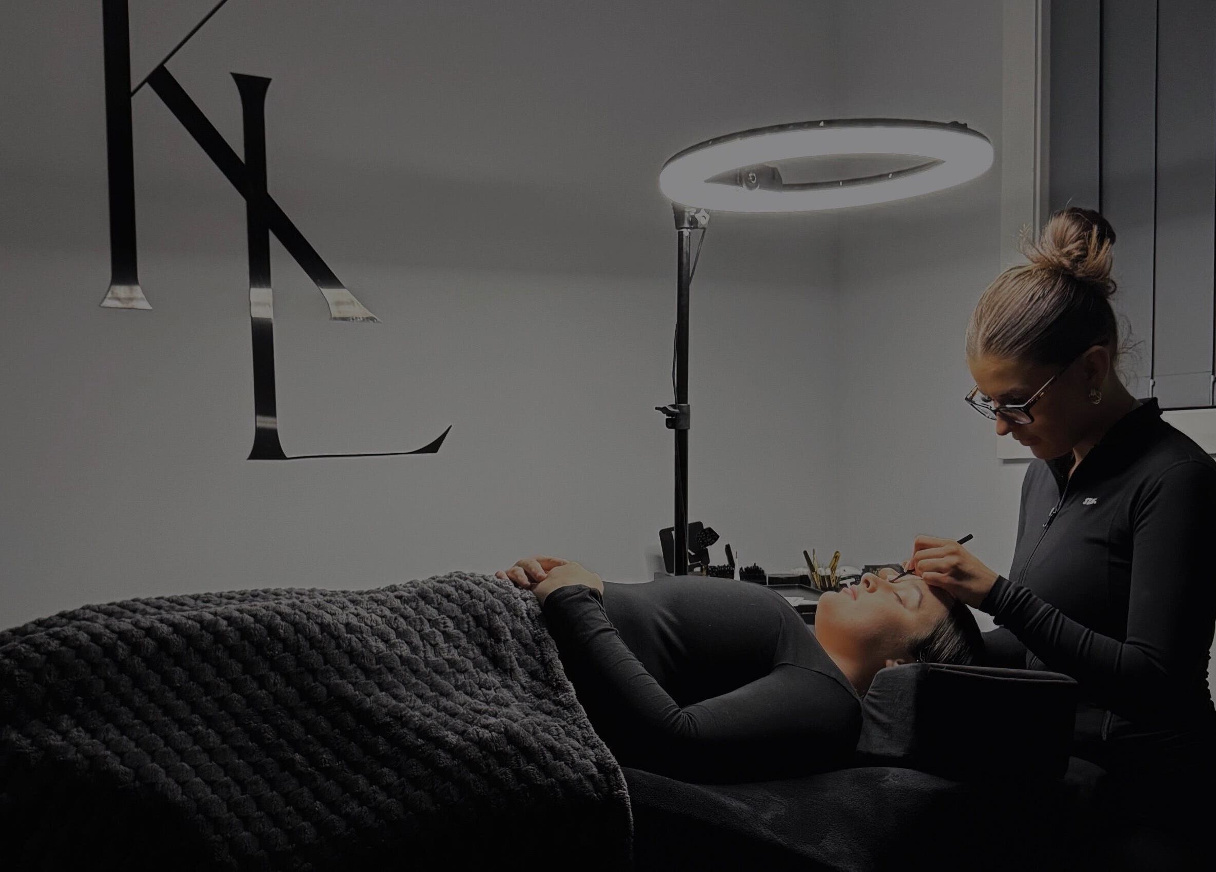 Expert applying eyelash extensions at LASHES BY KL in Tahmoor, New South Wales, AU under soft lighting.