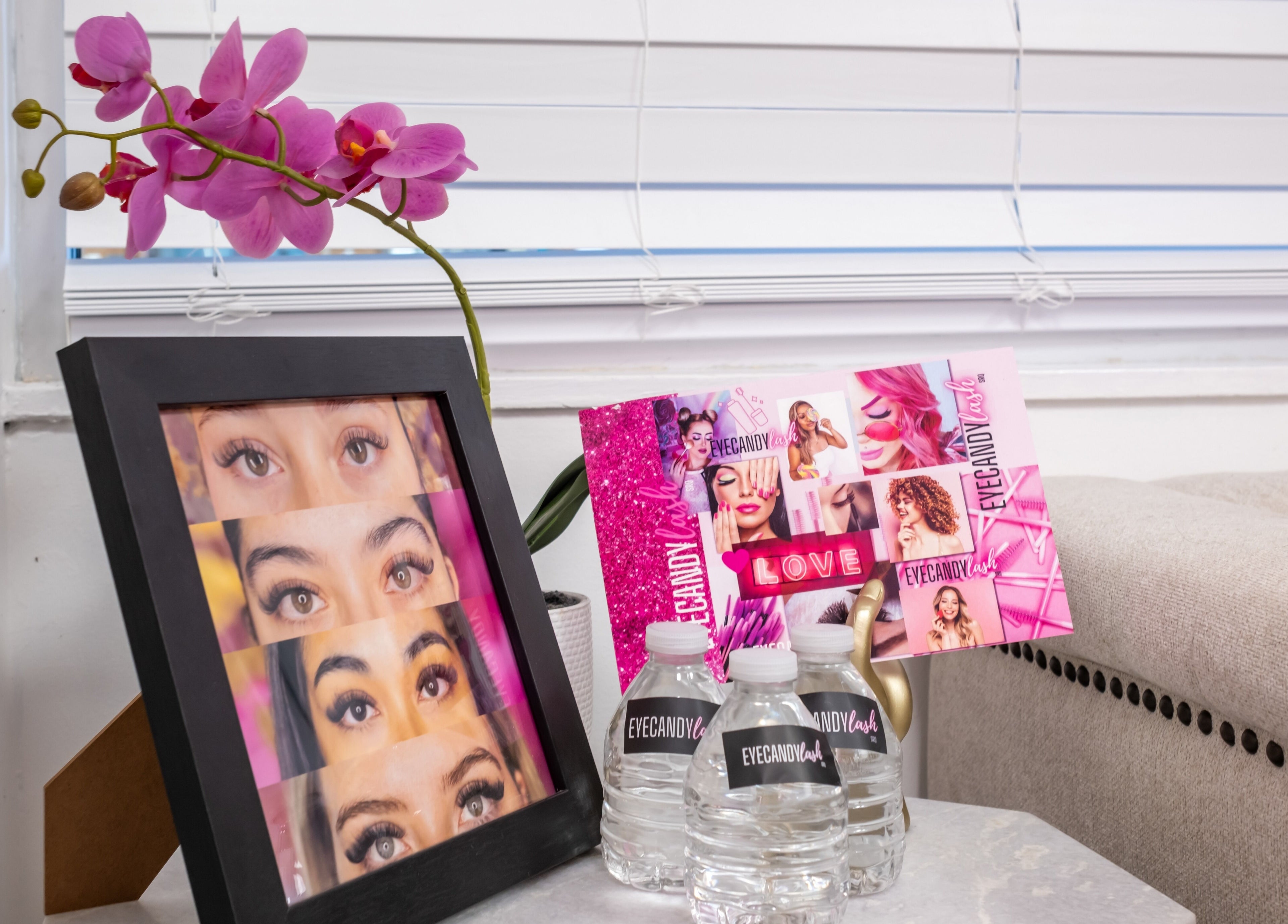 Framed eyelash photos and promotional materials at Eye Candy Lash and Brow Bar, Sarasota, Florida, US.