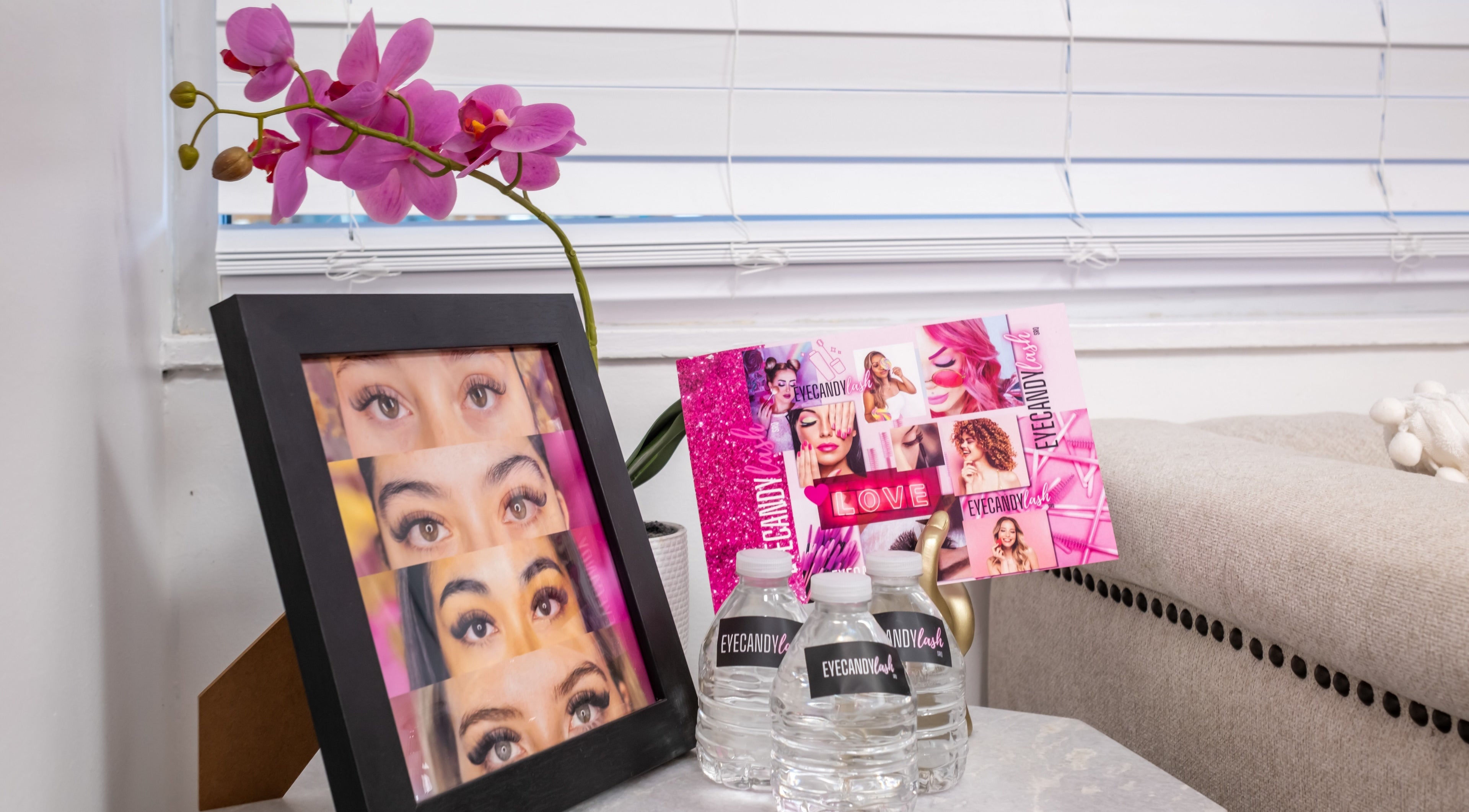 Framed eyelash photos and promotional materials at Eye Candy Lash and Brow Bar, Sarasota, Florida, US.