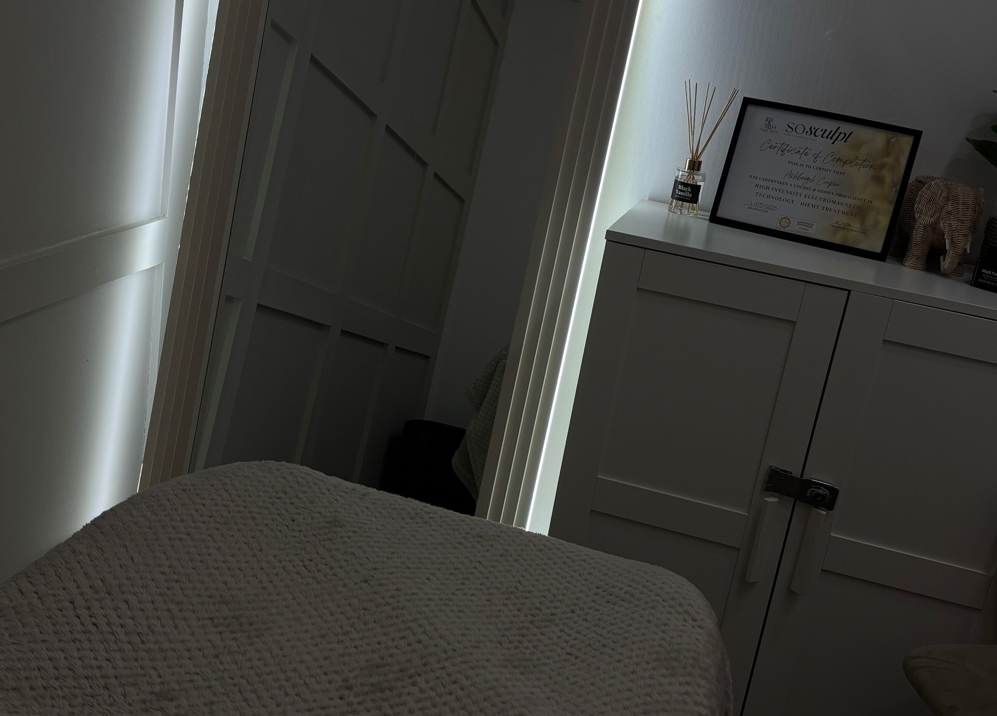 Tranquil treatment room at Sculpted by Ashleigh, Moreton, England. Cozy and inviting spa ambiance.