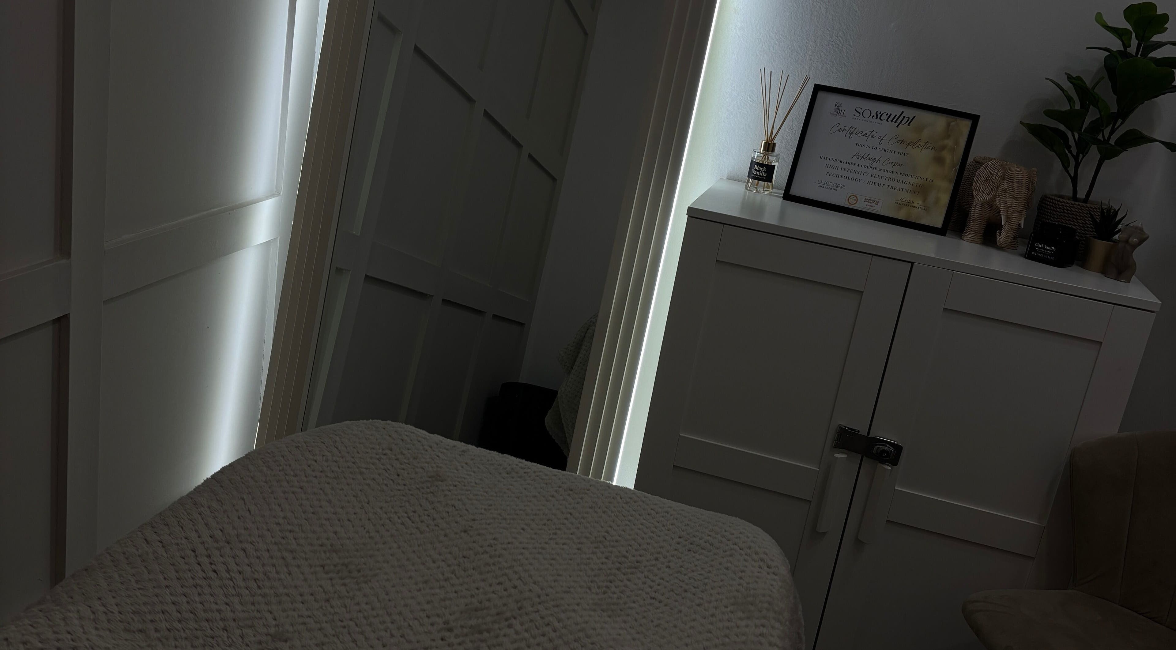 Tranquil treatment room at Sculpted by Ashleigh, Moreton, England. Cozy and inviting spa ambiance.