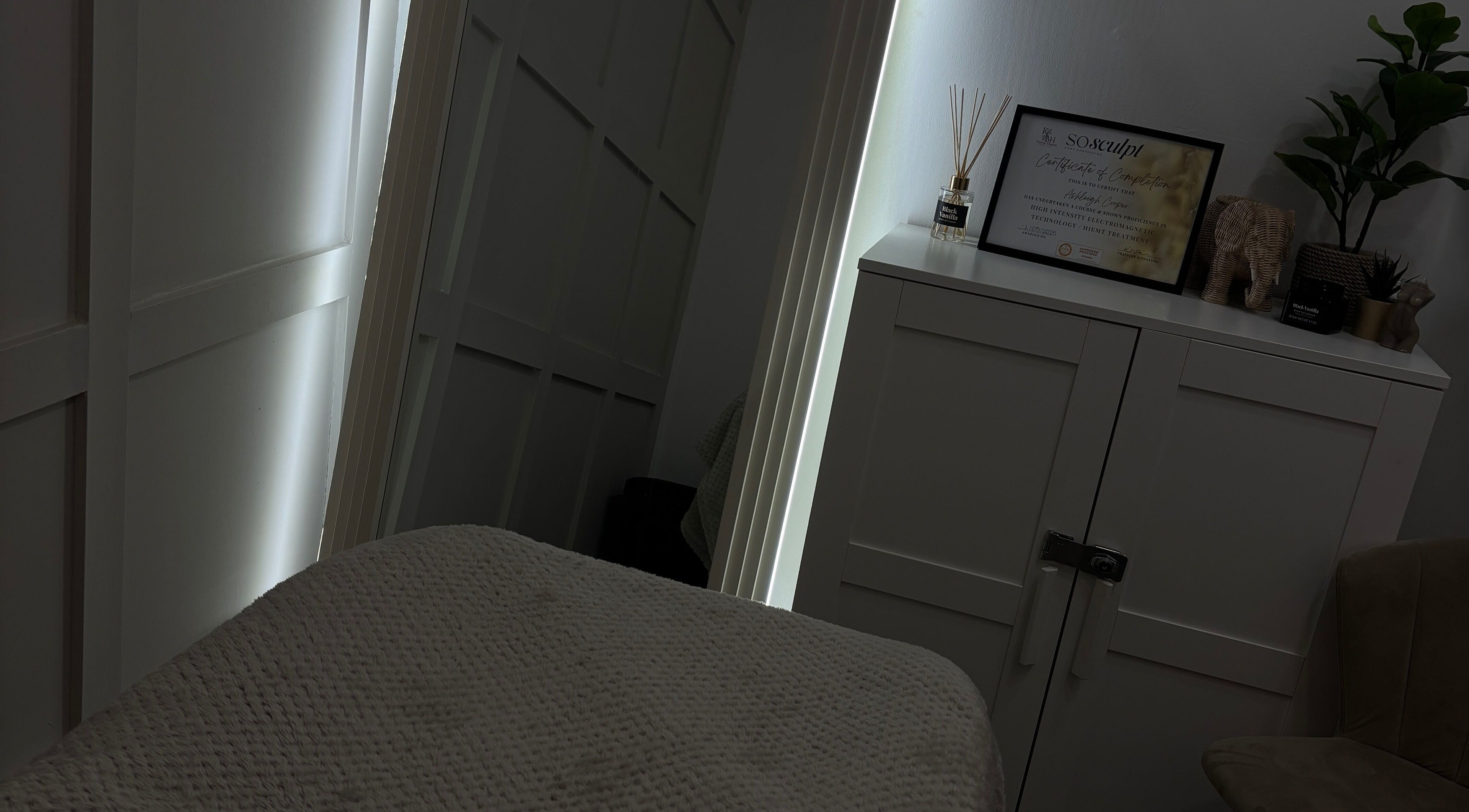 Tranquil treatment room at Sculpted by Ashleigh, Moreton, England. Cozy and inviting spa ambiance.