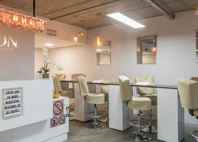 Chic interior of Swoon Beauty & Aesthetics, Ballito, Kwazulu-natal, ZA, featuring elegant seating and ambient lighting.