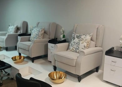 Relaxing pedicure area at Swoon Beauty & Aesthetics, Ballito, Kwazulu-natal, ZA with plush chairs and gold bowls.