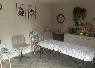 Relaxing treatment room at James Aesthetics in Northampton, England, GB, featuring a massage table and soothing decor.