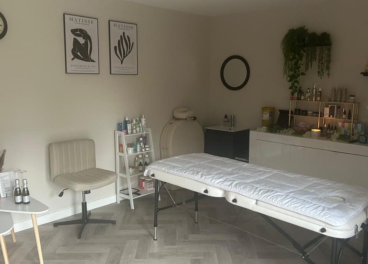 Peaceful therapy room at James Aesthetics in Northampton, England, GB, featuring a massage bed and calming decor.