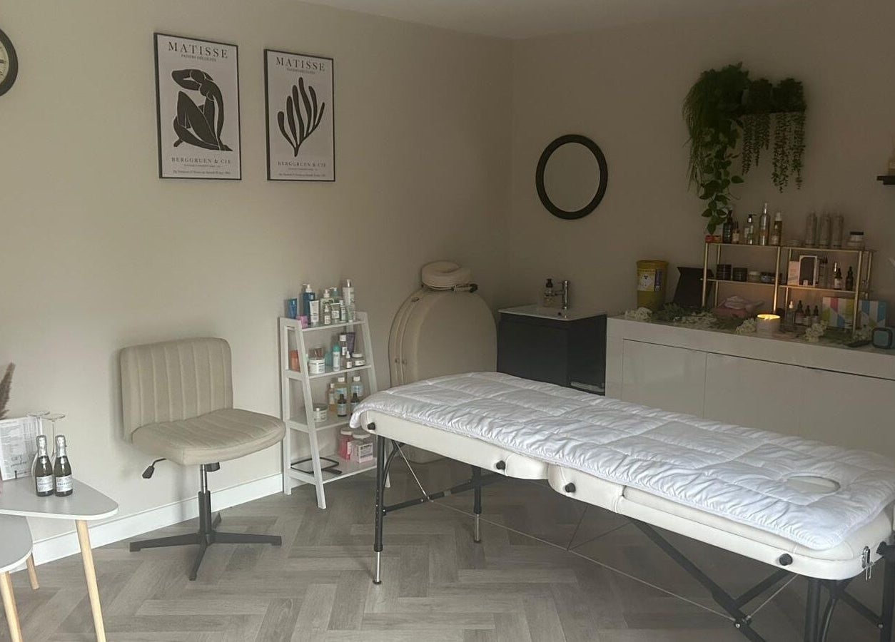 Peaceful therapy room at James Aesthetics in Northampton, England, GB, featuring a massage bed and calming decor.