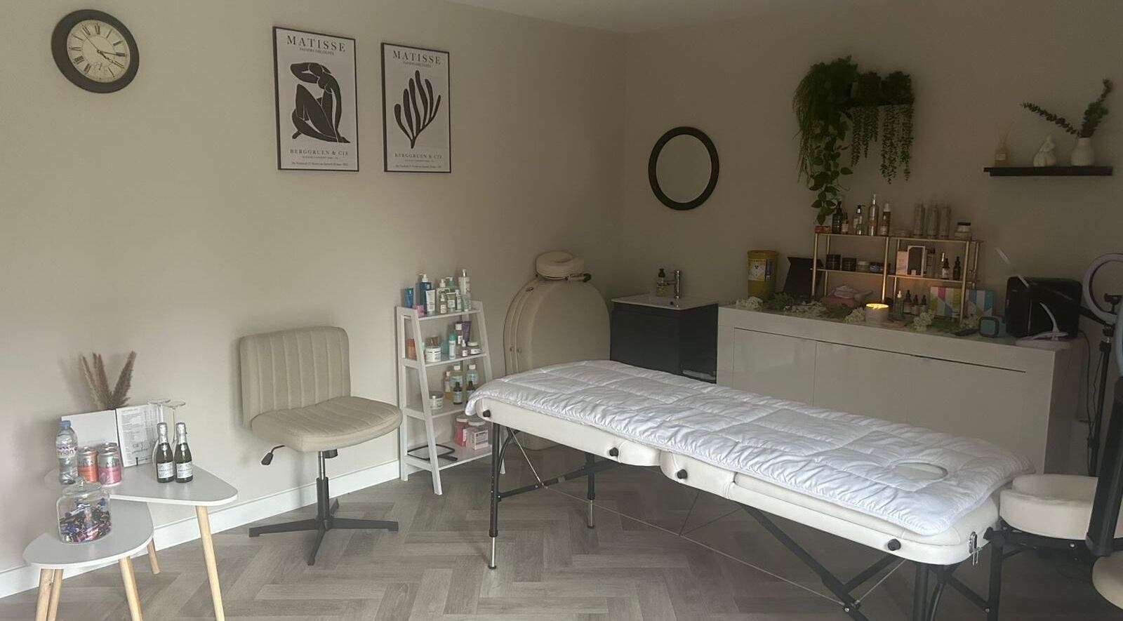 Peaceful therapy room at James Aesthetics in Northampton, England, GB, featuring a massage bed and calming decor.