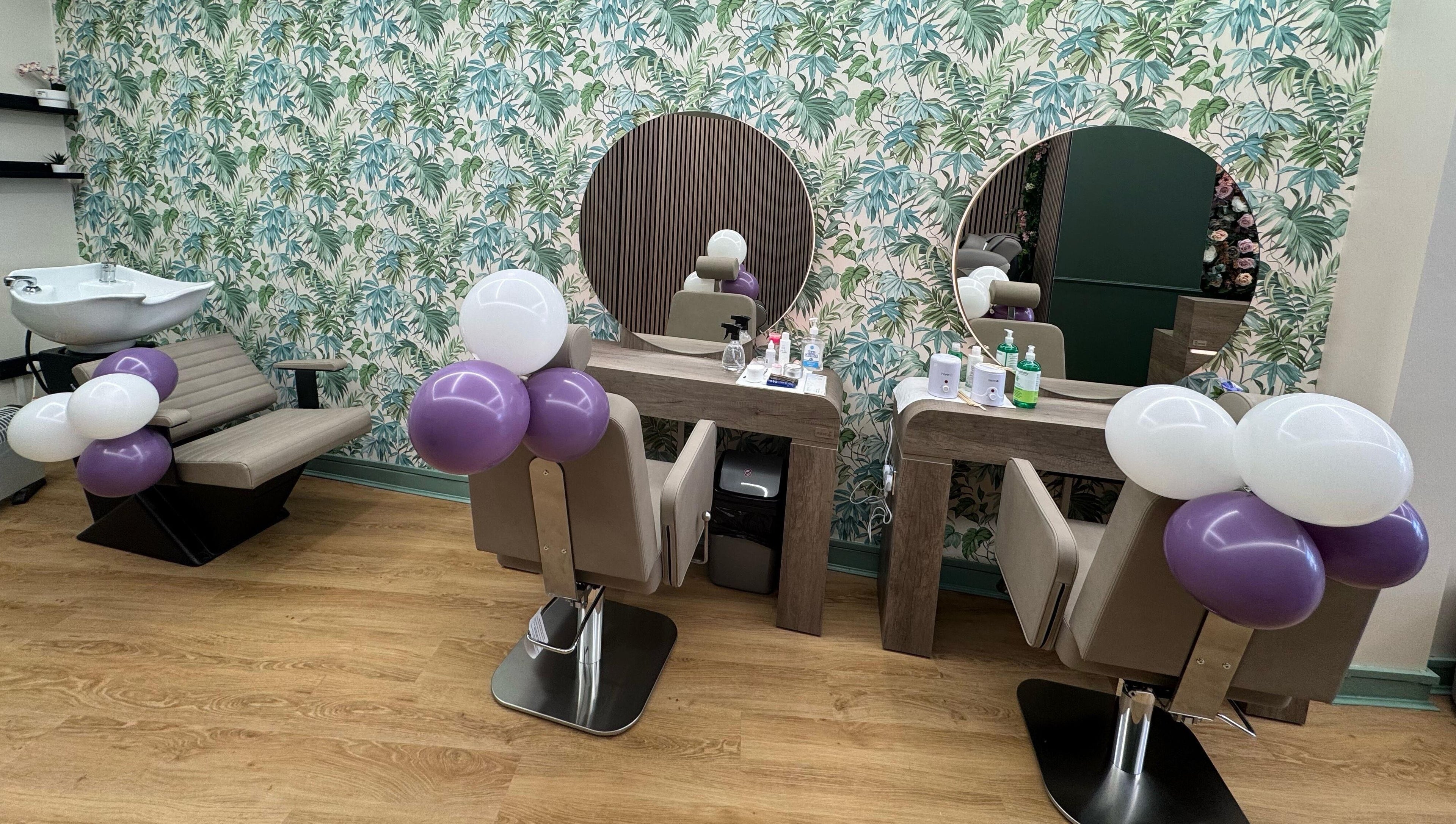 Stylish salon interior at Beauty Studio By K in St. Neots, England, GB with lush wallpaper and chic seating.