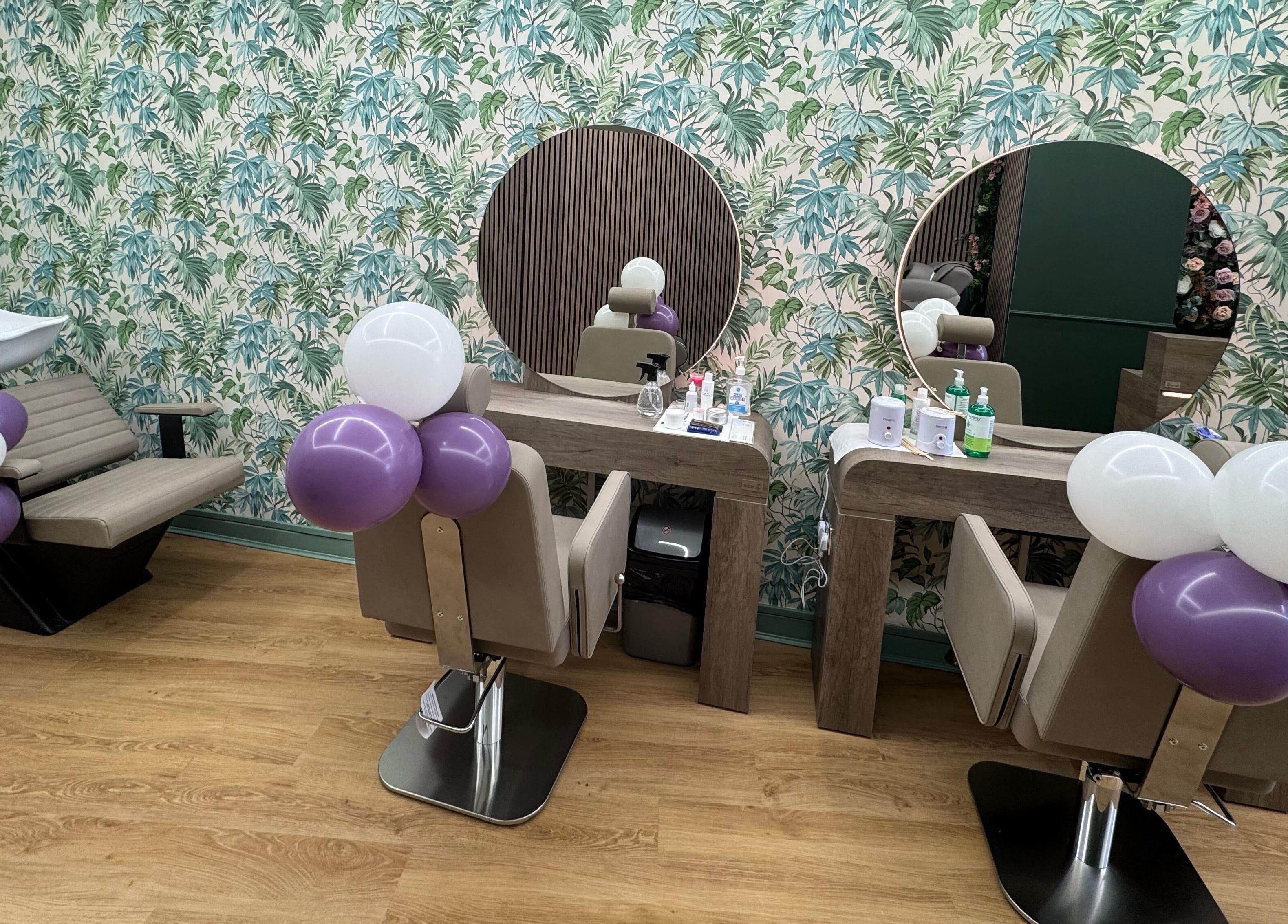 Stylish salon interior at Beauty Studio By K in St. Neots, England, GB with lush wallpaper and chic seating.