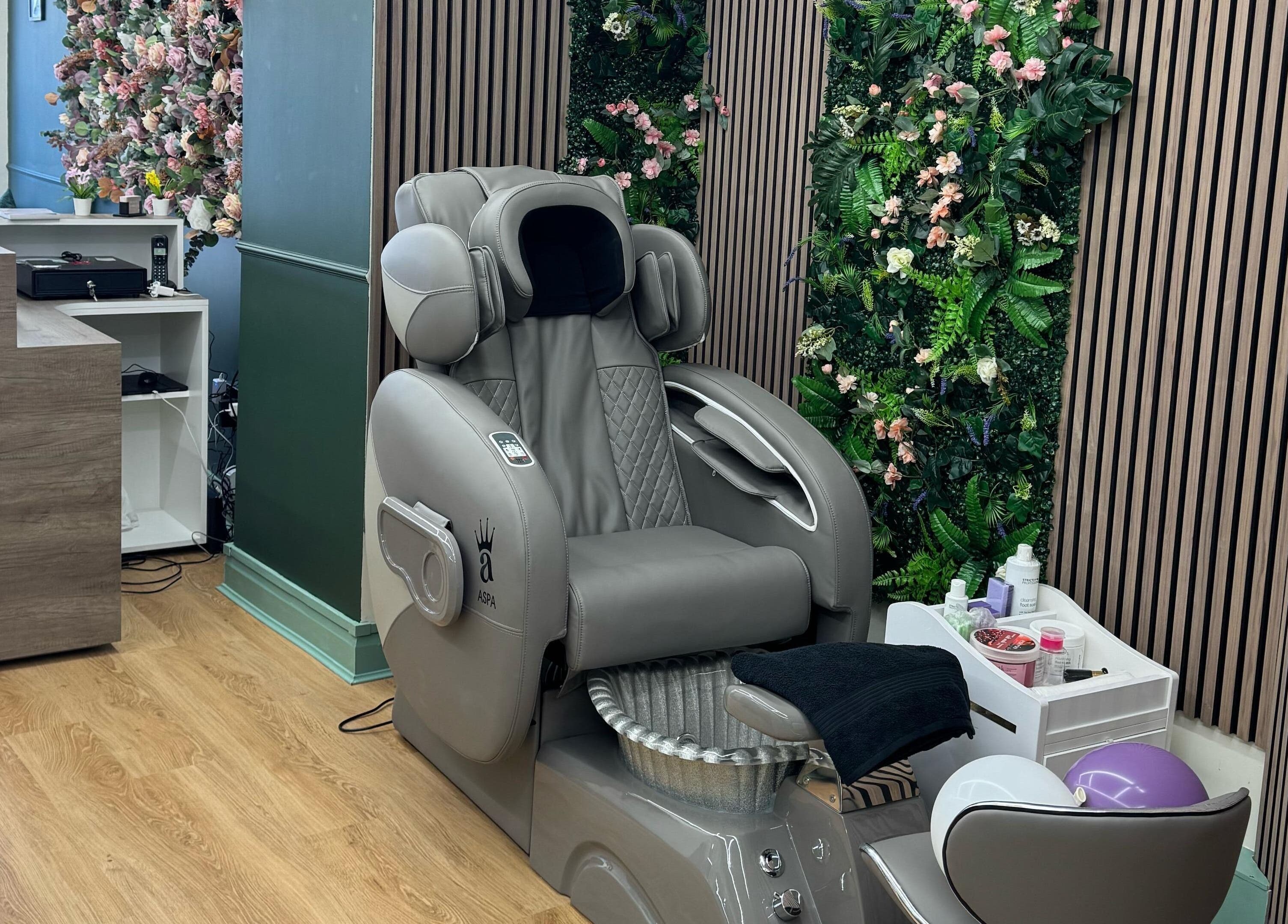 Elegant massage chair against a flower wall at Beauty Studio By K, St. Neots, England, GB.