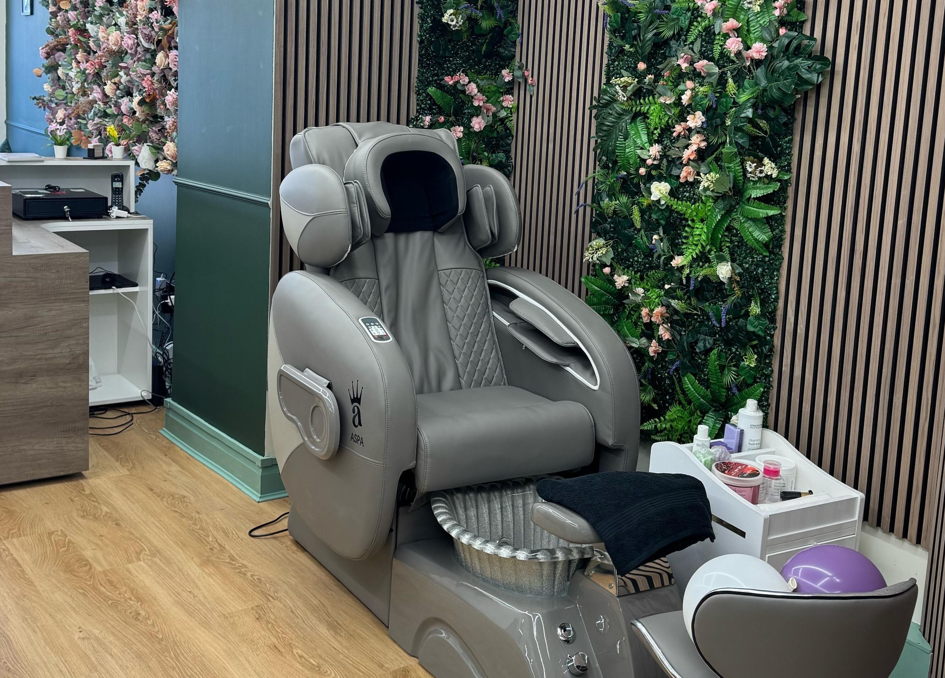 Elegant massage chair against a flower wall at Beauty Studio By K, St. Neots, England, GB.