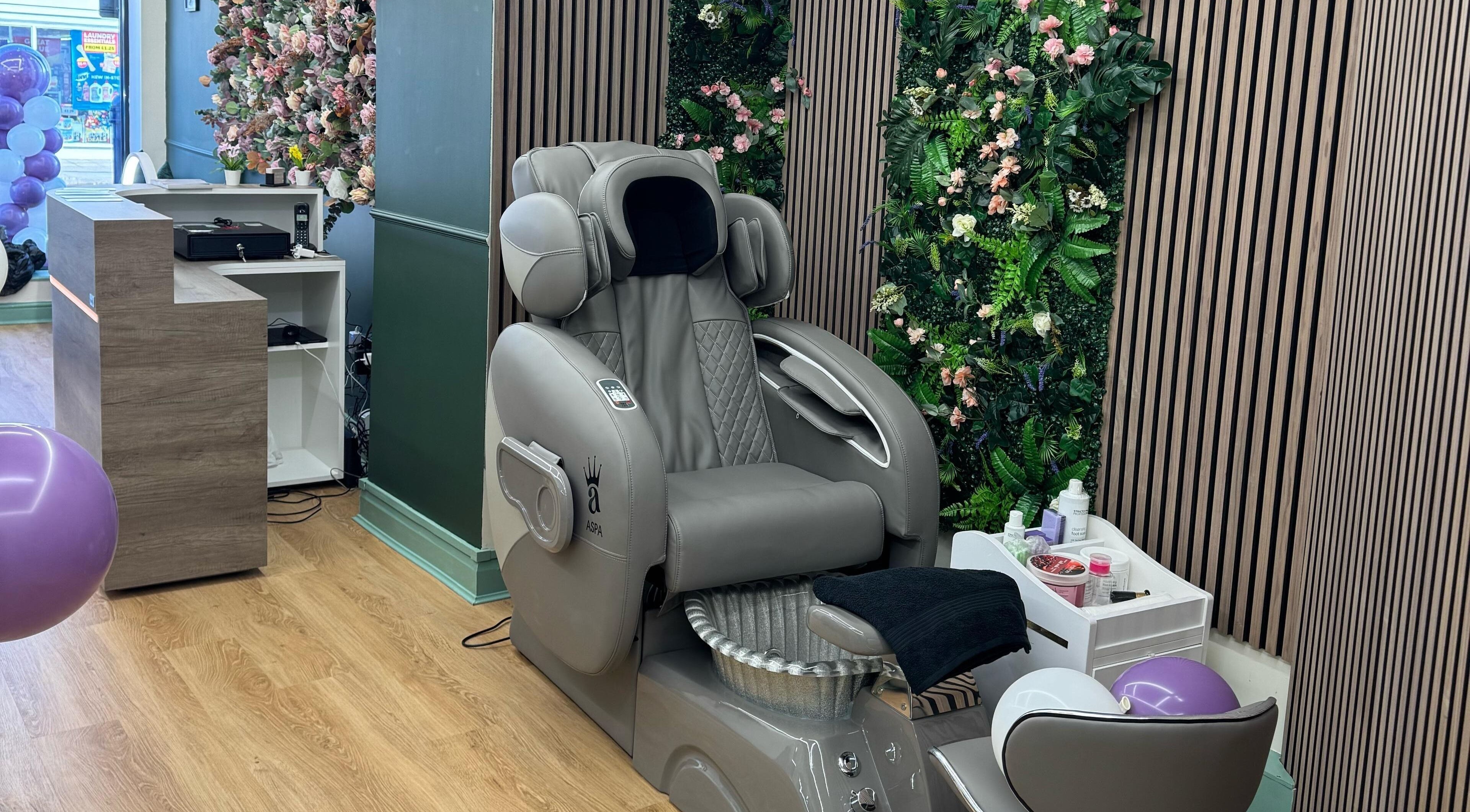 Elegant massage chair against a flower wall at Beauty Studio By K, St. Neots, England, GB.
