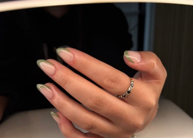Manicured hand with green-tipped nails at Serenity Beauty Studio, Ashton-in-Makerfield, England, GB.
