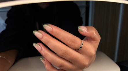 Manicured hand with green-tipped nails at Serenity Beauty Studio, Ashton-in-Makerfield, England, GB.