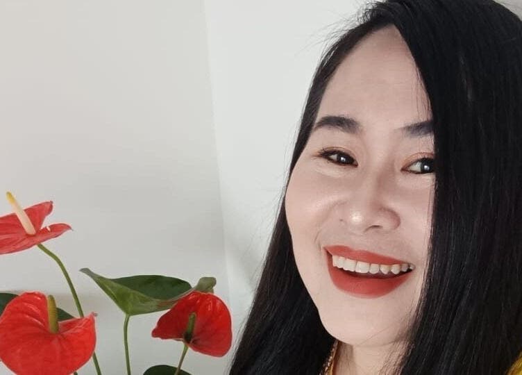 Smiling person with flowers at Lek Ka Thai Massage Studio in Cape Town, Western Cape, ZA.