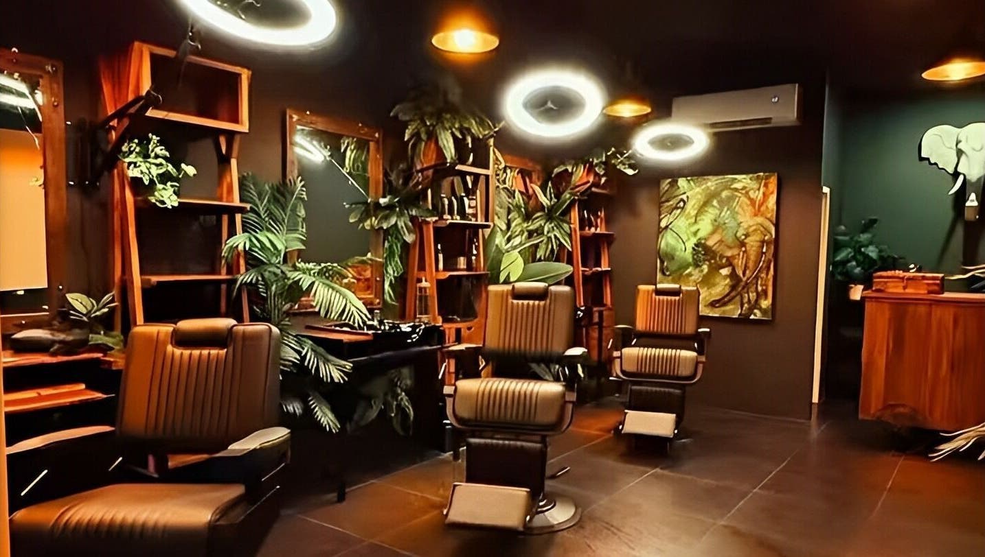 Chic interior of Wild Barber Boat Avenue in Choeng Thale, Phuket featuring stylish chairs and lush plants.