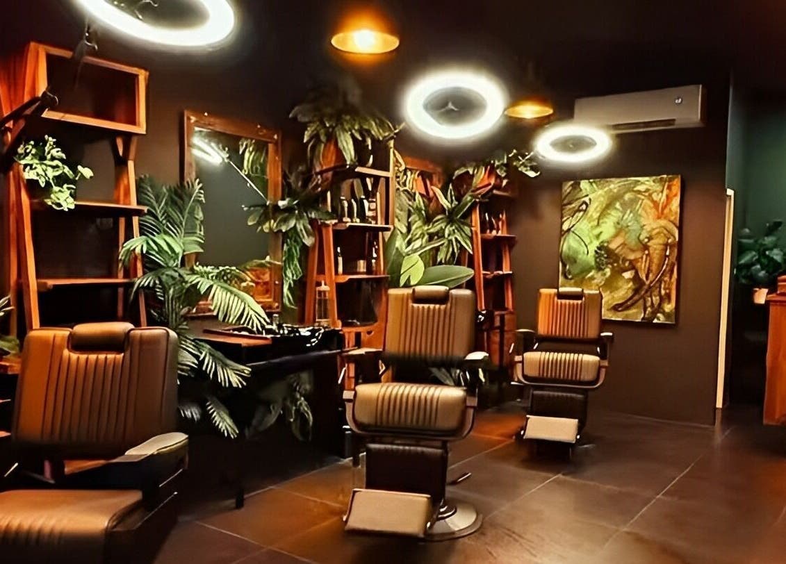 Chic interior of Wild Barber Boat Avenue in Choeng Thale, Phuket featuring stylish chairs and lush plants.