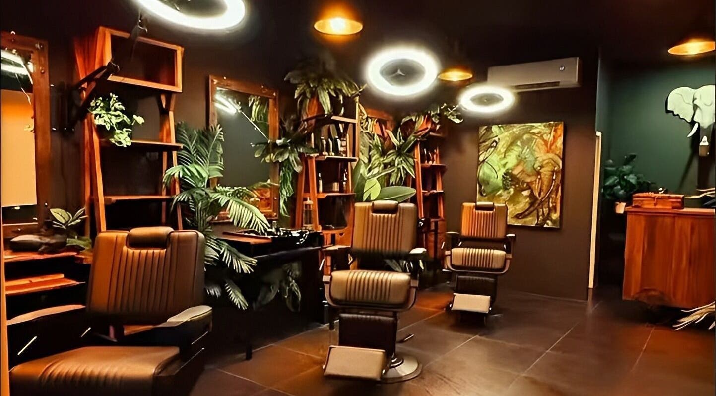 Chic interior of Wild Barber Boat Avenue in Choeng Thale, Phuket featuring stylish chairs and lush plants.