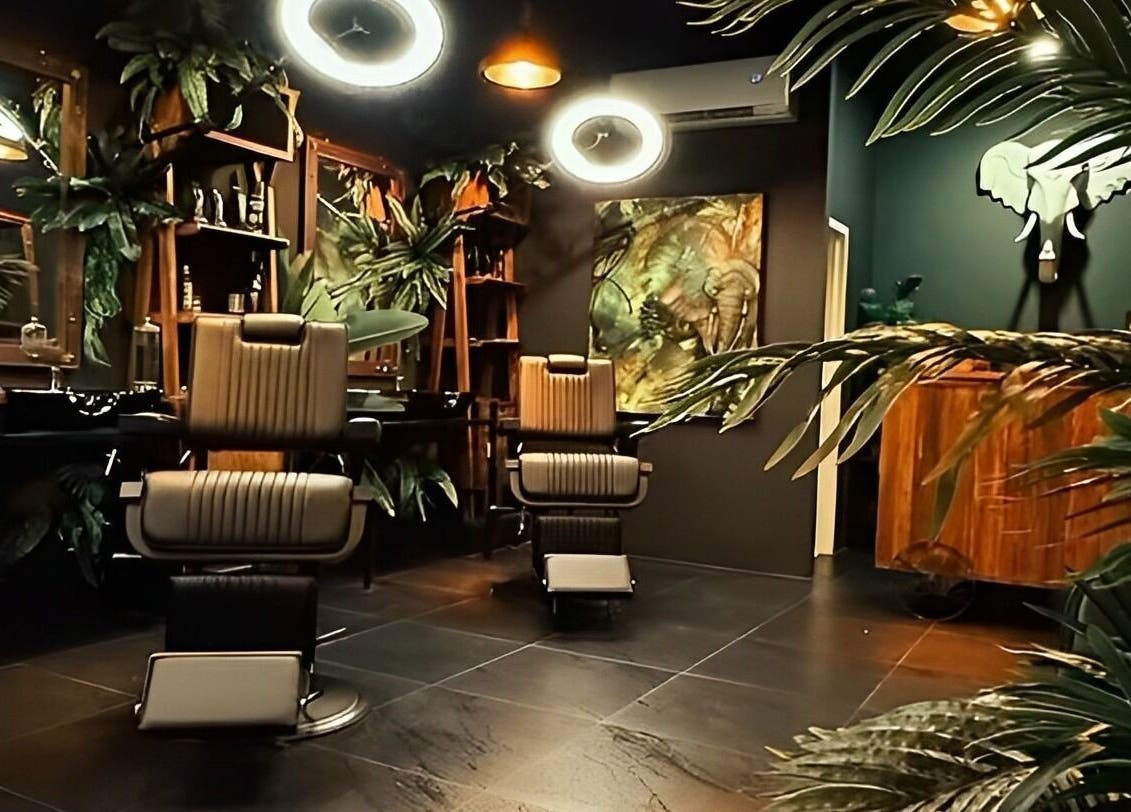 Stylish interior of Wild Barber Boat Avenue in Choeng Thale, Phuket, TH with modern decor and comfy chairs.