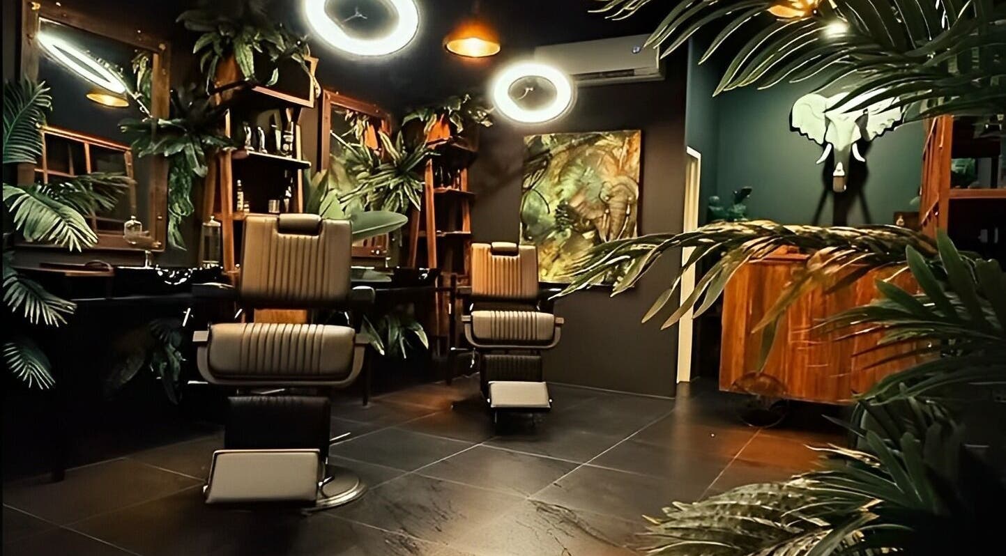 Stylish interior of Wild Barber Boat Avenue in Choeng Thale, Phuket, TH with modern decor and comfy chairs.