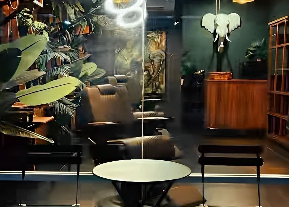 Cozy interior of Wild Barber Boat Avenue in Choeng Thale, Phuket, TH, featuring lush greenery and stylish decor.