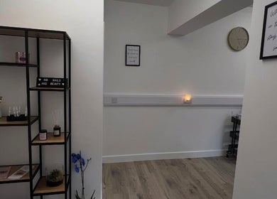 Cozy interior of AMP Beauty, Clay Cross, England featuring minimalist decor and calming ambiance.