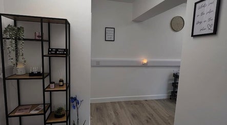 Cozy interior of AMP Beauty, Clay Cross, England featuring minimalist decor and calming ambiance.