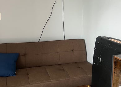 Brown sofa with blue cushion at Careful Touch venue, Detroit, Michigan, US.