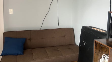 Brown sofa with blue cushion at Careful Touch venue, Detroit, Michigan, US.