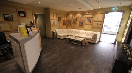 Elegant waiting area at Yinyang Spa-Village Mall, Dubai, Dubai, AE featuring plush seating and modern decor.