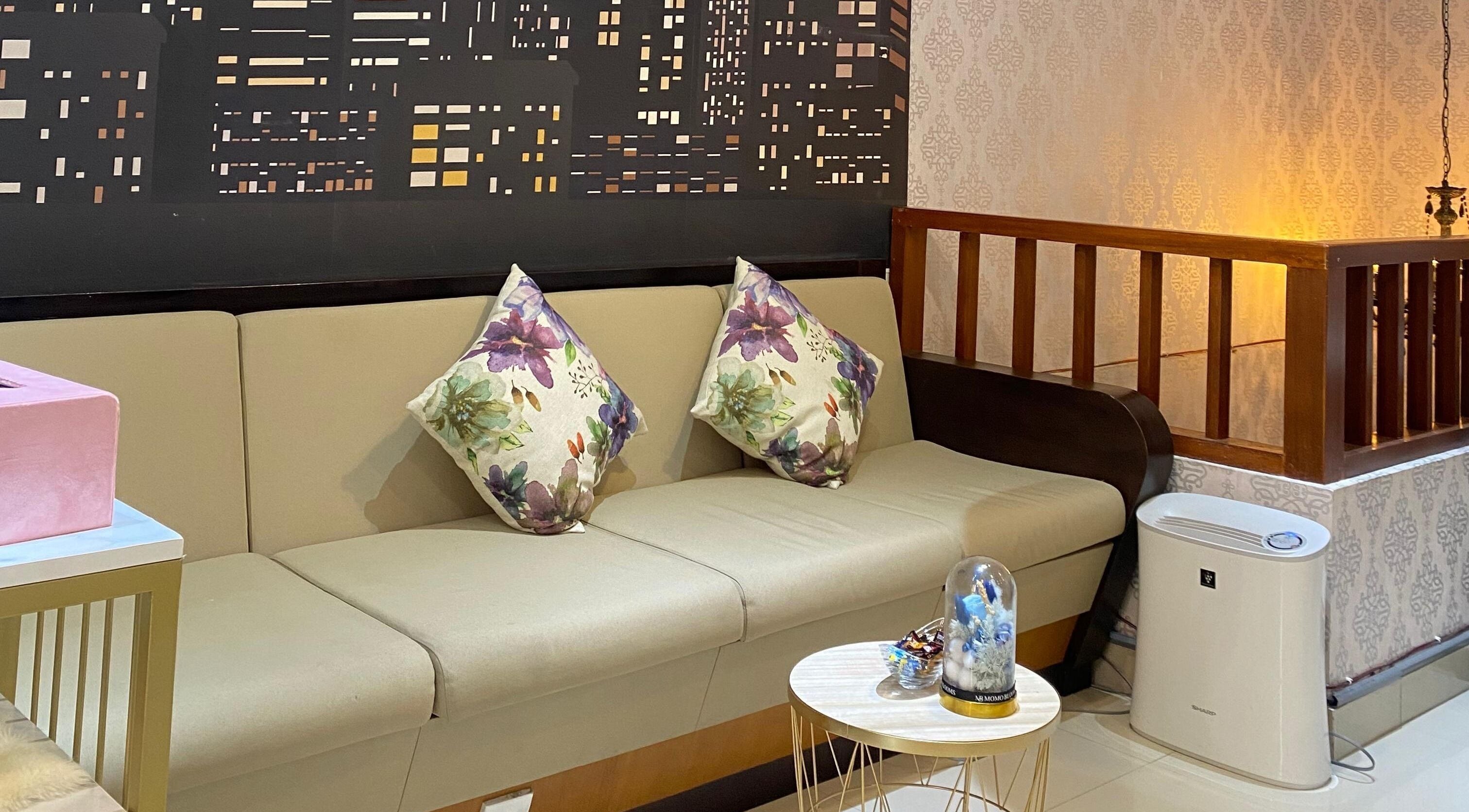 Inviting seating area at Le Naile Beauty Studio, Bali, Bali, ID with plush floral cushions.