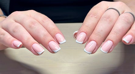 Stylish French manicure at Bydarcyella, Birmingham, England, GB, showcasing neat white tips on nude nails.