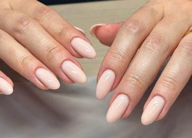 Elegant nude manicure by Bydarcyella in Birmingham, England, GB, showcasing glossy almond-shaped nails.