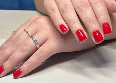 Vibrant red manicure at Bydarcyella, Birmingham, England, GB showcasing glossy, well-groomed nails.