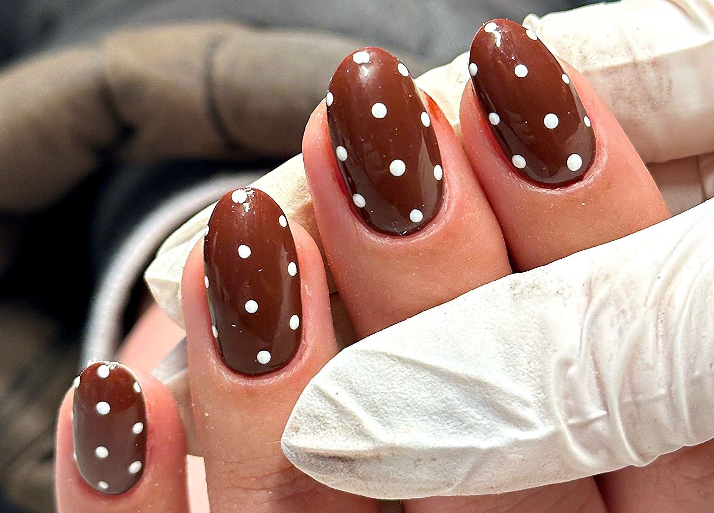 Close-up of chic polka dot nails at Bydarcyella, Birmingham, England, GB.