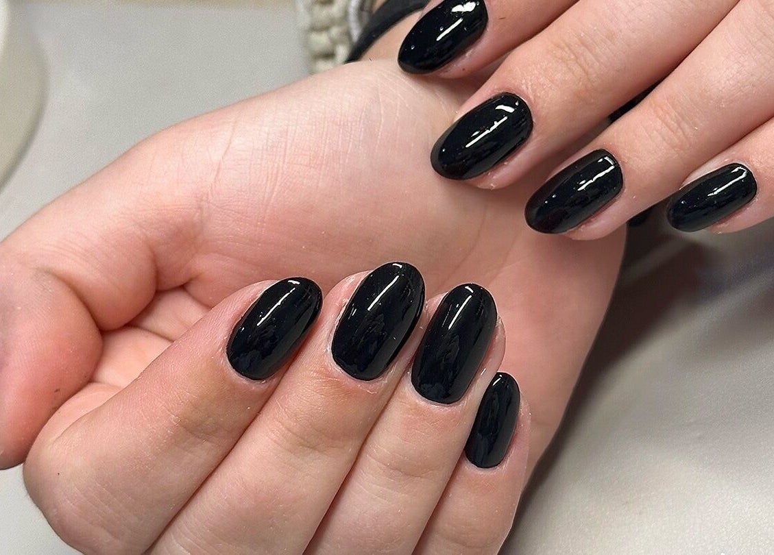 Elegant black manicure at Bydarcyella in Birmingham, England, GB showcasing glossy nail art.