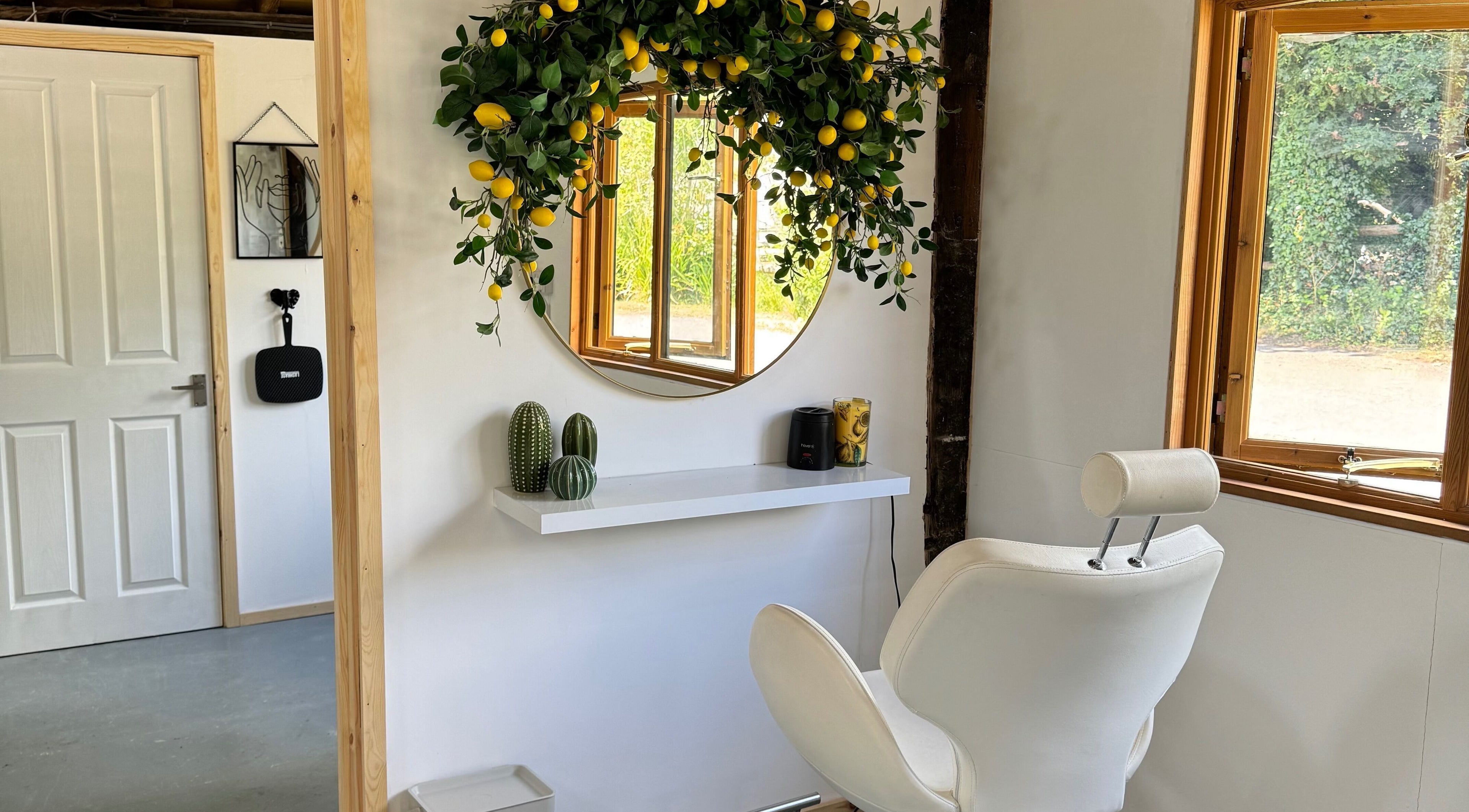 Bright beauty room at Grace & Beauty, Hayling Island, England. Features stylish chair, mirror, and lemon decor.