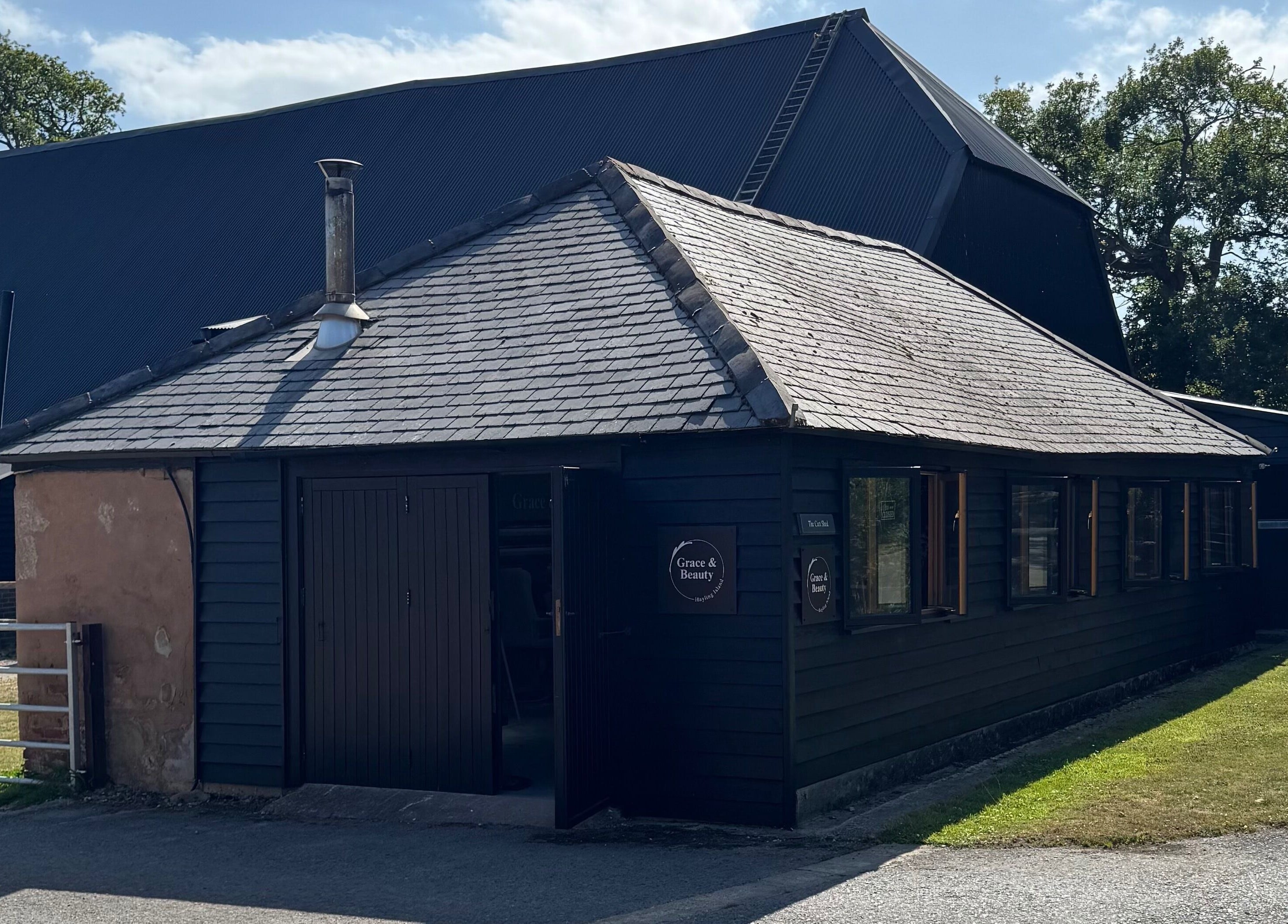Grace & Beauty venue exterior on Hayling Island, England, GB, with quaint dark wood paneling.