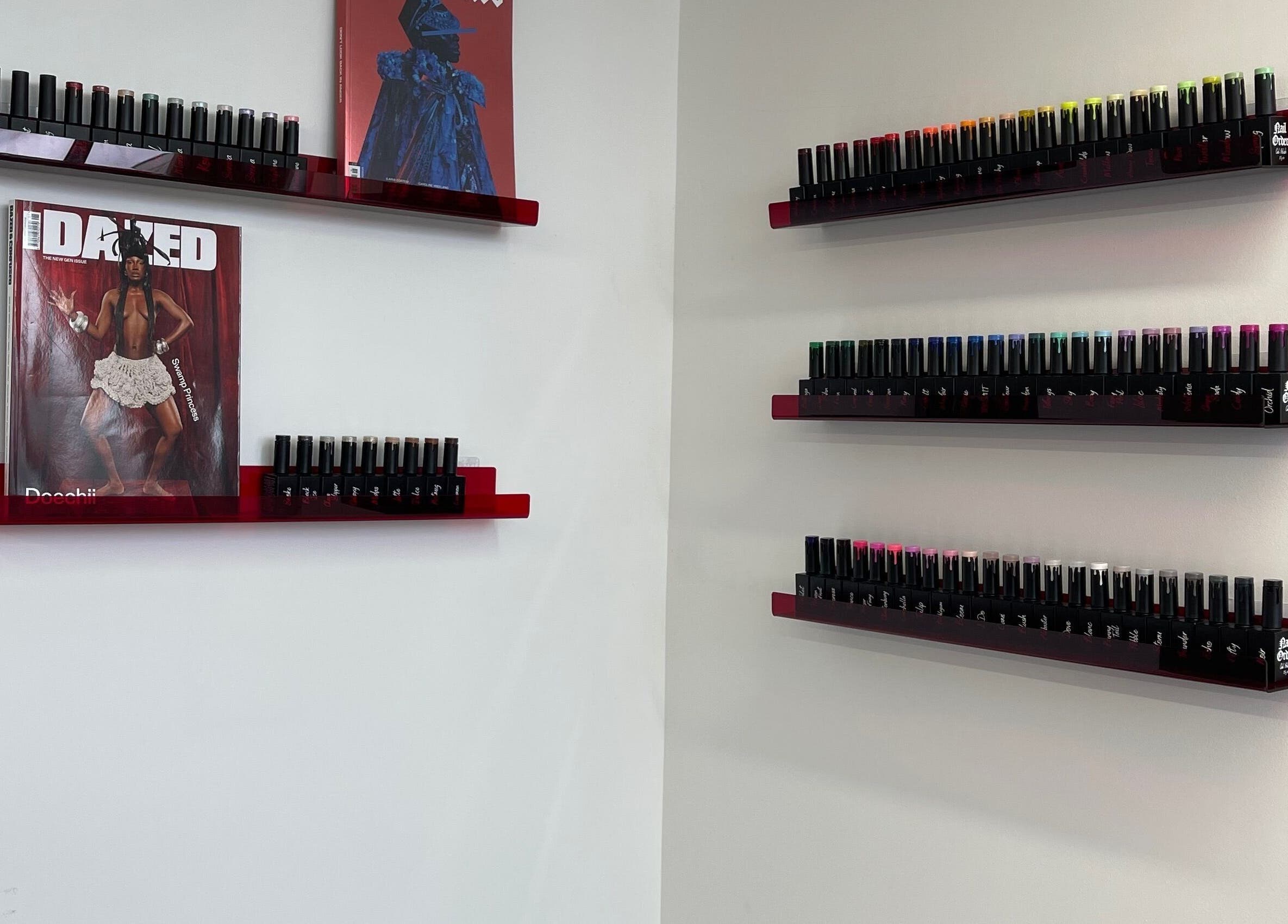 Nail polish display at Fashi0n.Victim in Manchester, England, GB showcases vibrant colors on sleek shelves.