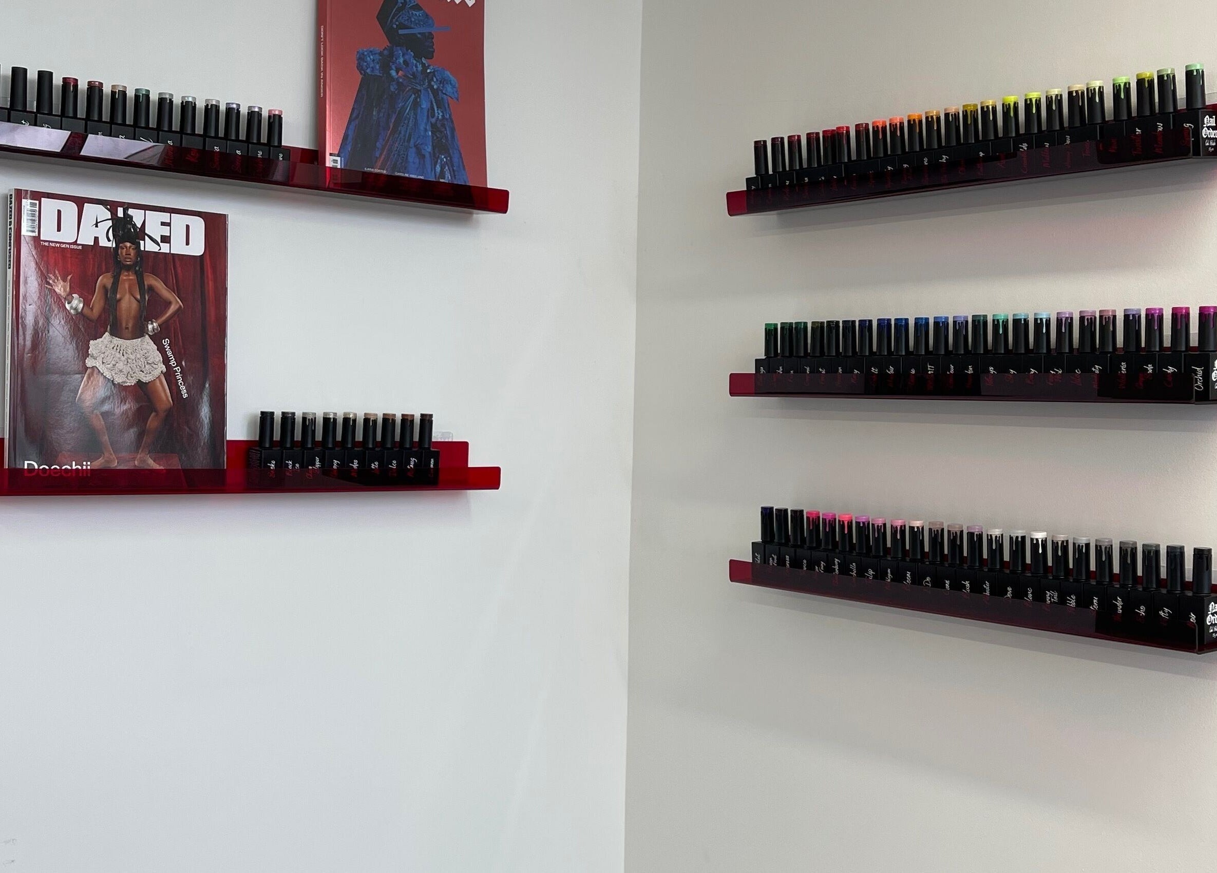 Nail polish display at Fashi0n.Victim in Manchester, England, GB showcases vibrant colors on sleek shelves.