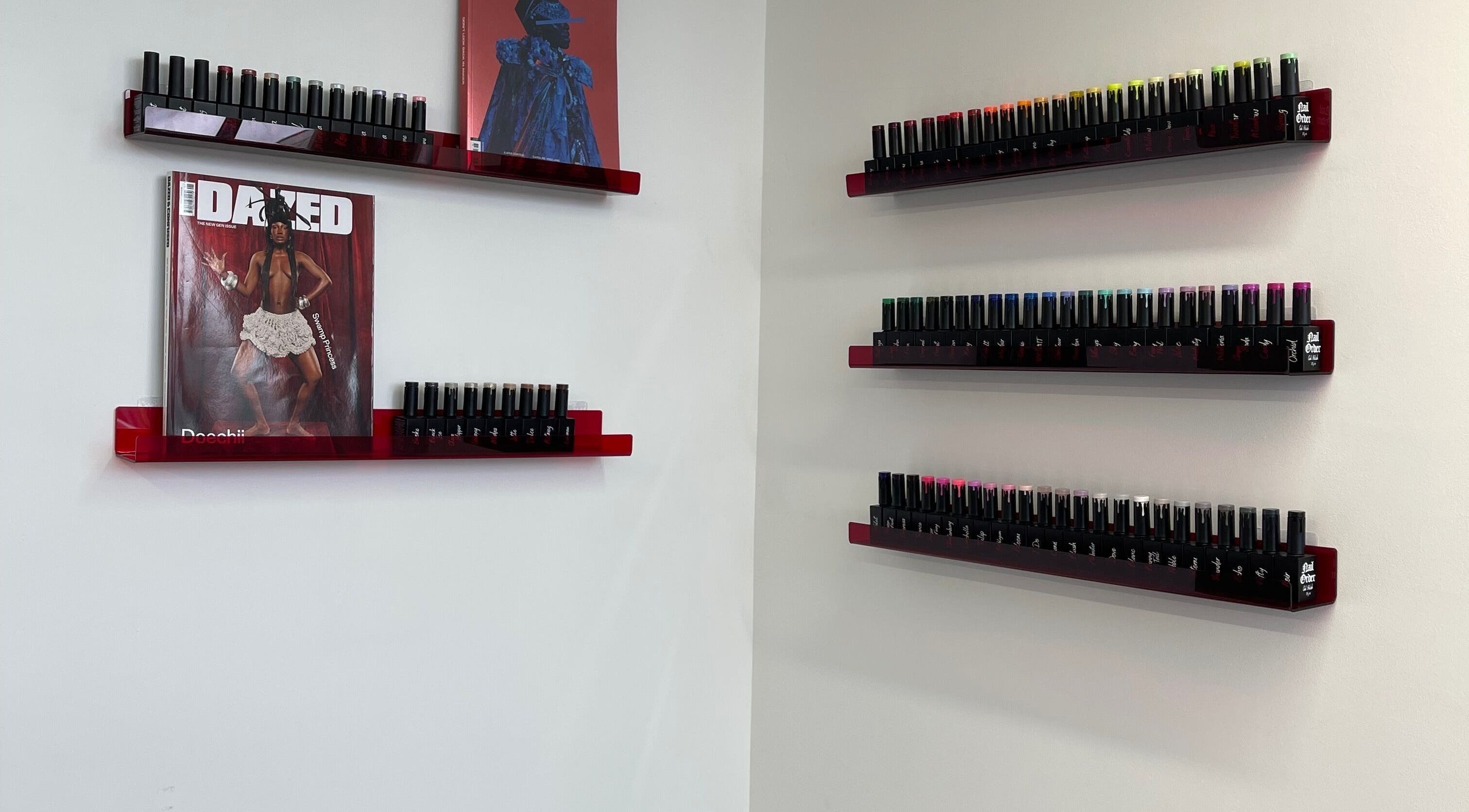 Nail polish display at Fashi0n.Victim in Manchester, England, GB showcases vibrant colors on sleek shelves.