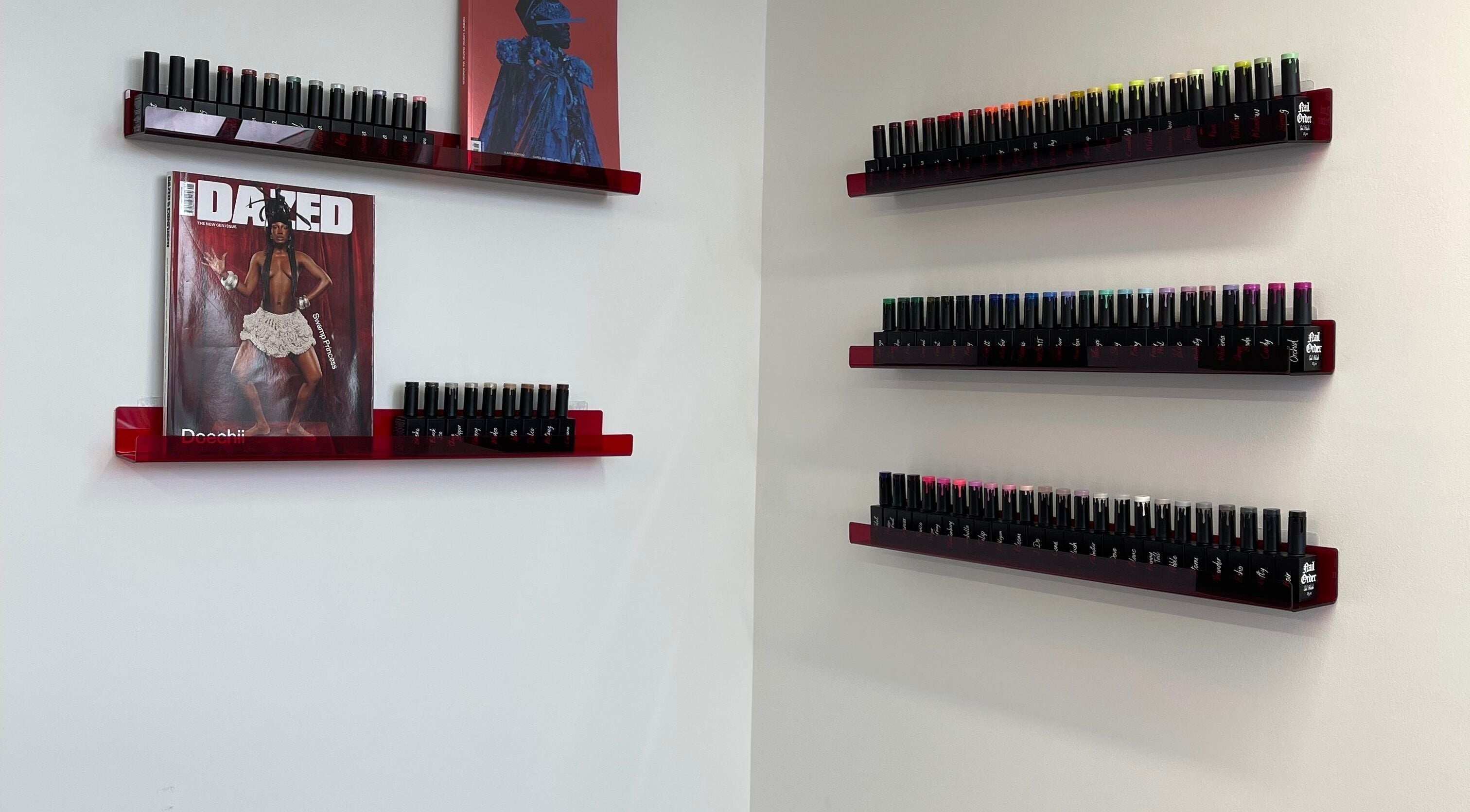 Nail polish display at Fashi0n.Victim in Manchester, England, GB showcases vibrant colors on sleek shelves.