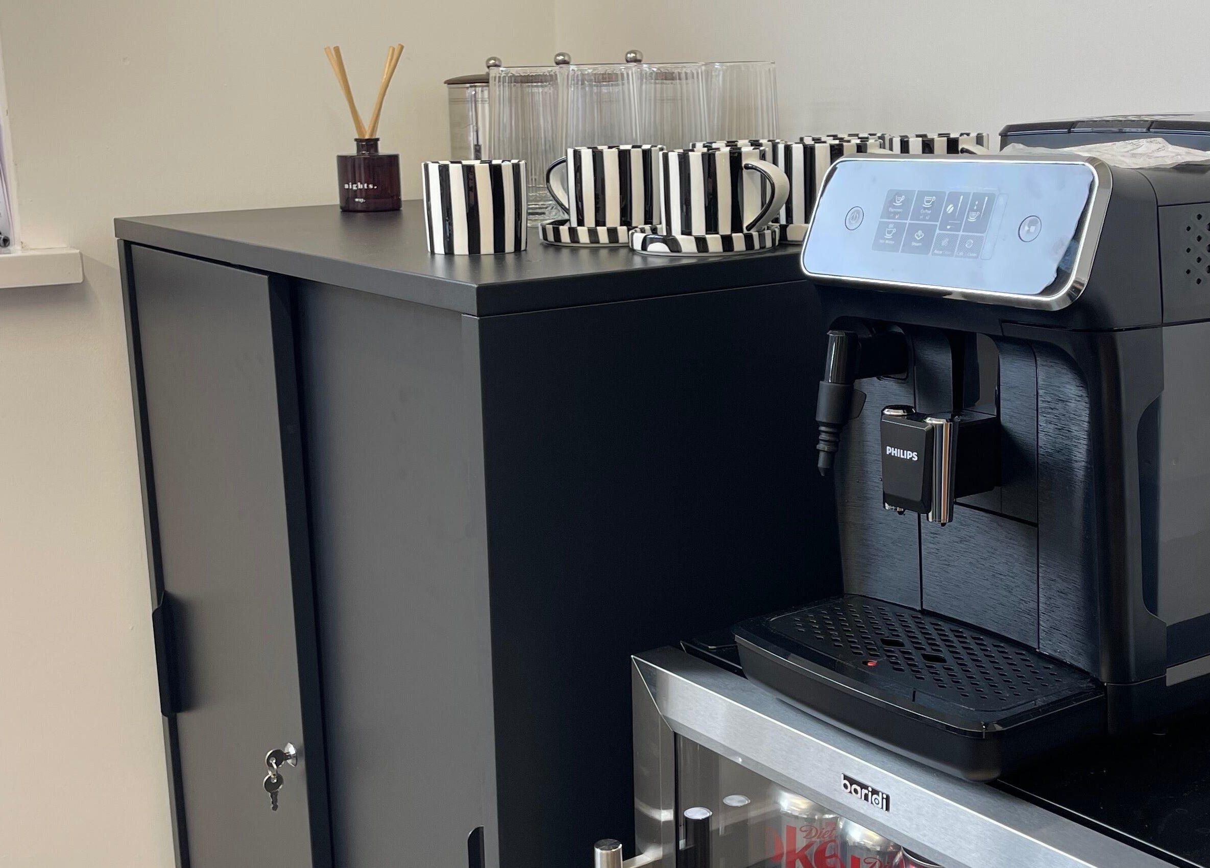 Coffee station with striped cups and espresso machine at Fashi0n.Victim, Manchester, England, GB.