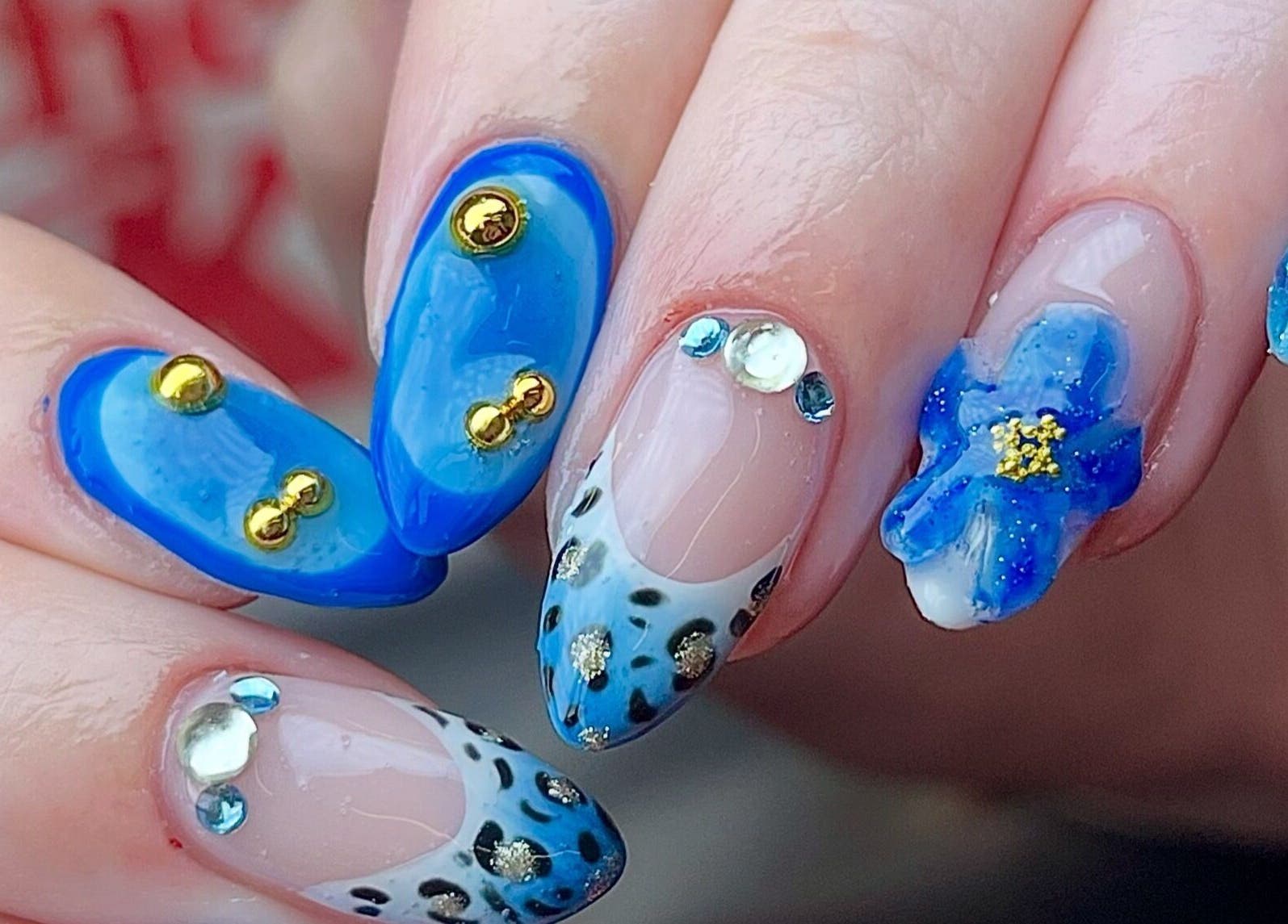 Detailed blue and gem nail art at Fashi0n.Victim, Manchester, England, GB showcasing intricate designs.