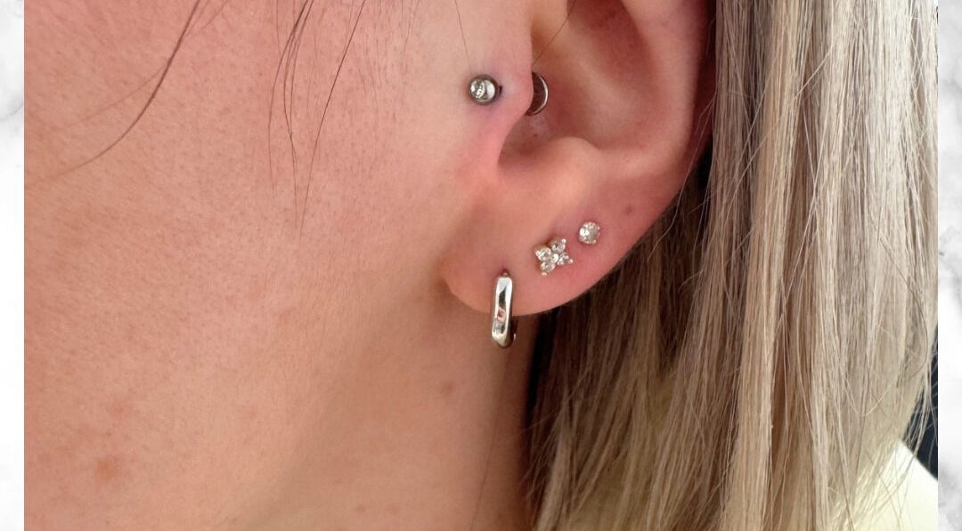 Stylish ear piercings at Selina Janes, Ayr, Scotland, GB featuring multiple elegant earrings.