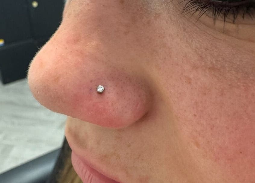 Close-up of a nose piercing with a diamond stud at Selina Janes in Ayr, Scotland, GB.