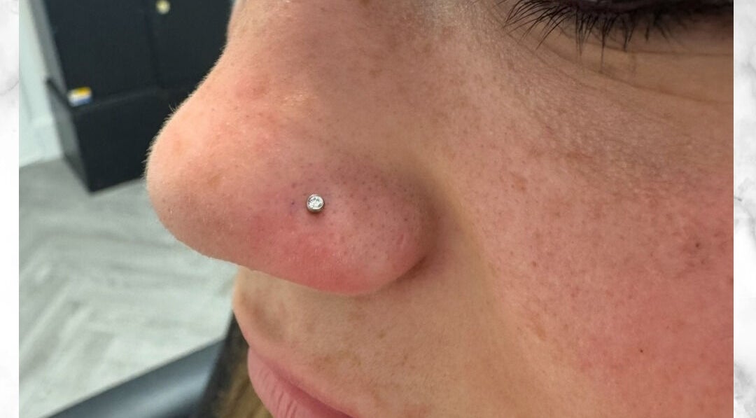 Close-up of a nose piercing with a diamond stud at Selina Janes in Ayr, Scotland, GB.