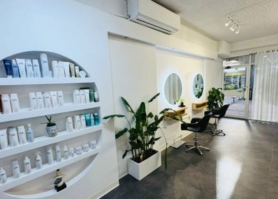 Zen by the Bay salon interior with sleek shelves and mirrors at Shoal Bay, New South Wales, AU.