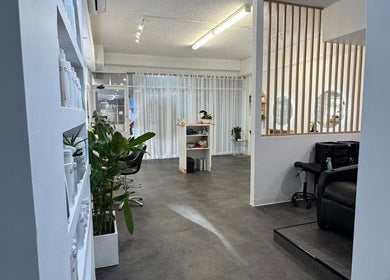 Chic interior of Zen by the Bay, Shoal Bay, New South Wales, AU showcasing elegant decor and salon chairs.
